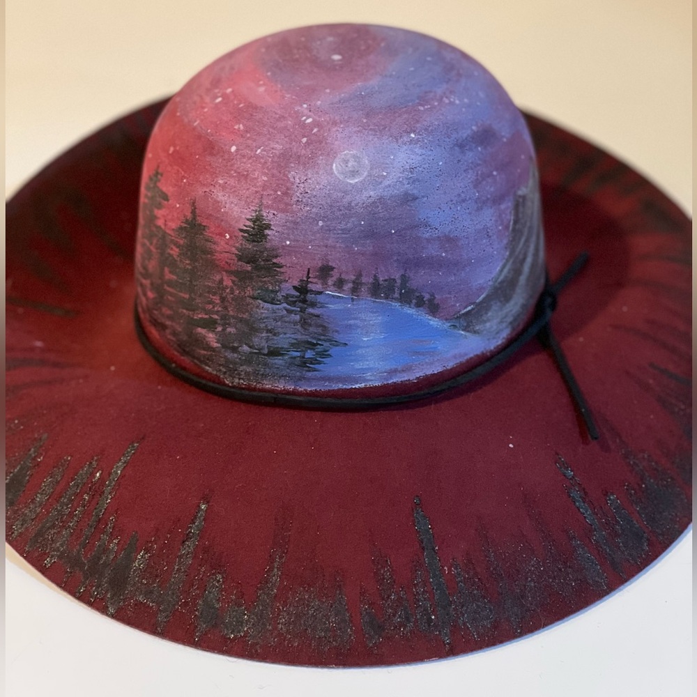 Hand painted 100% wool hat with leather trim.